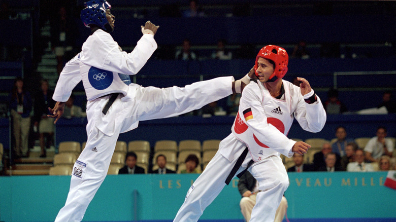 Ángel Matos kicking an opponent in 2000