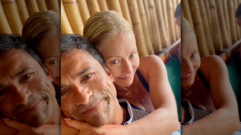 Mark Consuelos cuddles Kelly Ripa.