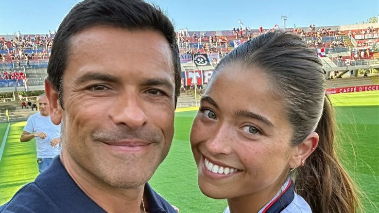 Mark Consuelos poses with his daughter Lola on a soccer field.