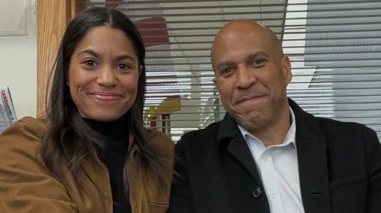 Alexis Lewis and Cory Booker posing for cameras