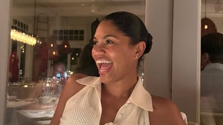 Alexis Lewis posing for cameras at restaurant