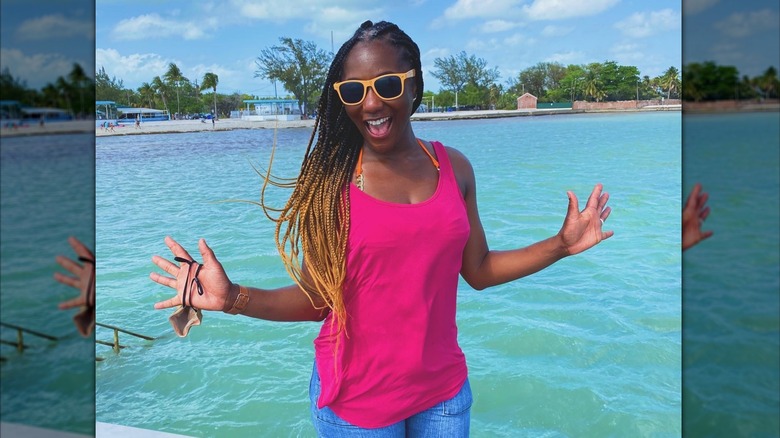 Krystal Anderson poses in a pink shirt