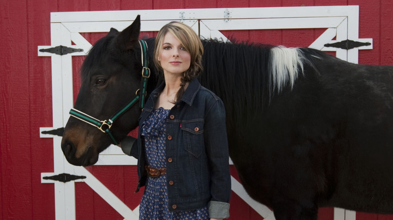 Lisa Kelly next to a horse in Alaska
