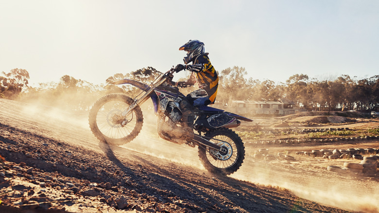Man racing dirt bike in desert