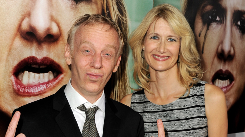 Mike White posing with Laura Dern in front of poster for Enlightened