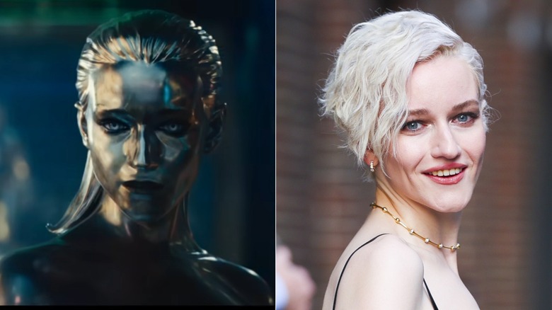 Julia Garner as Silver Surfer in "Fantastic Four: First Steps" / Julia Garner with a platinum blonde wavy pixie cut wearing a black top with a high white collar and black bows tied to it