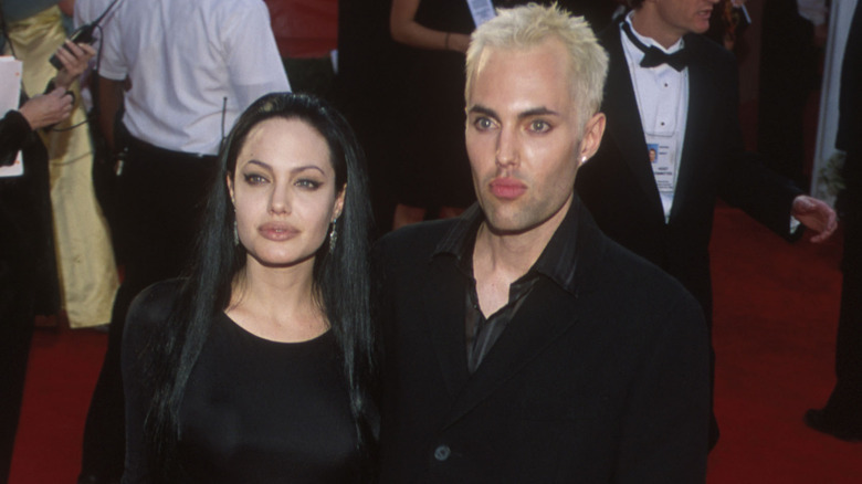 Angelina Jolie, James Haven posing on red carpet