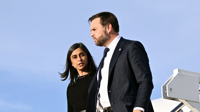 Usha Vance speaking to her husband JD Vance as they walk together