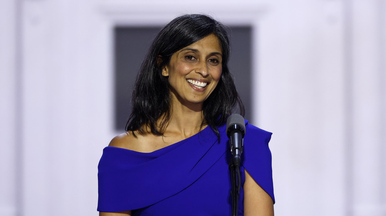 Usha Vance smiling with teeth wearing a blue dress