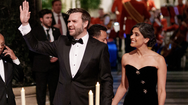 JD Vance waving while Usha Vance walks beside him