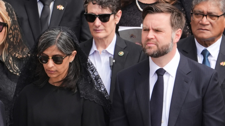 Usha Vance wearing a veil and standing next to JD Vance at Pope Leo XIV's inauguration mass