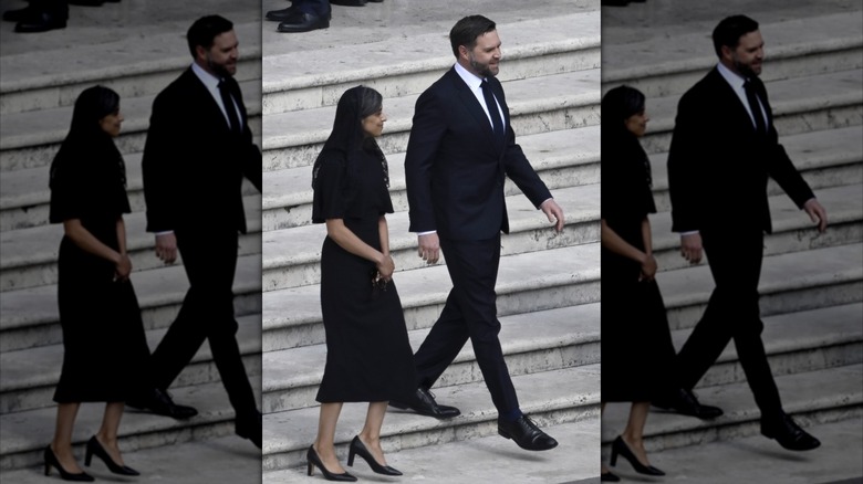Wearing an all-black look, Usha Vance walks down the steps in the company of JD Vance