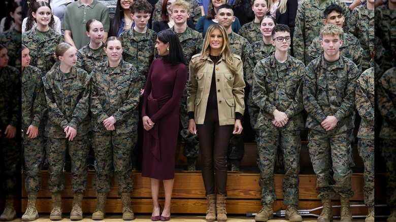 Usha Vance looks away from the camera in a group photo with Melania Trump and military personnel