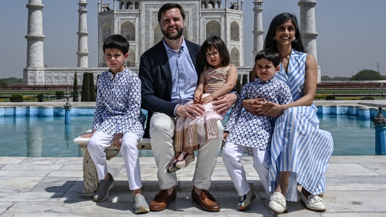 Wearing a striped blue dress, Usha Vance is all smiles in a group photo with her family