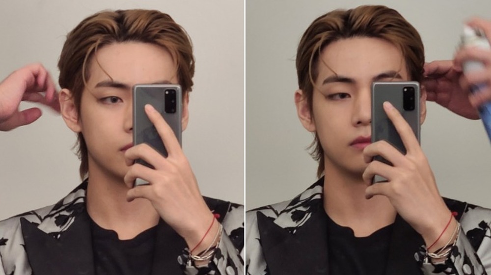 V poses in mirror with slick hair and suit