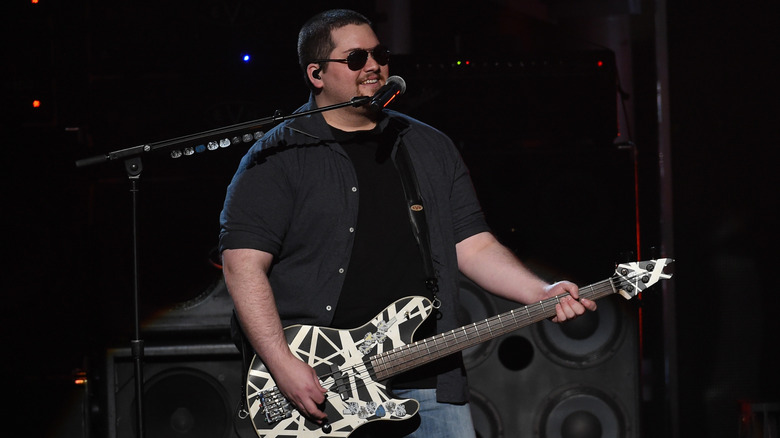 Wolfgang Van Halen smiling and performing on stage