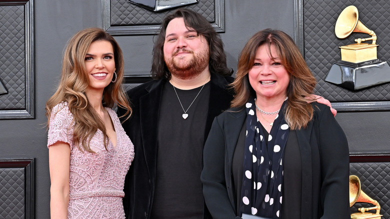 Wolfgang Van Halen posing at the Grammys with his mother and wife