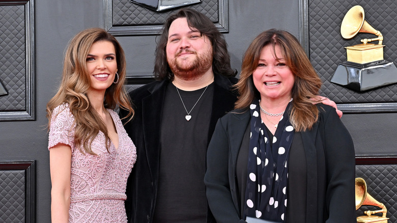 Wolfgang Van Halen posing at the Grammys with his mother and wife
