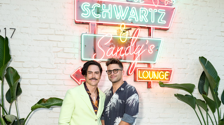 Tom Sandoval, Tom Schwartz posing with Schwartz & Sandy's sign