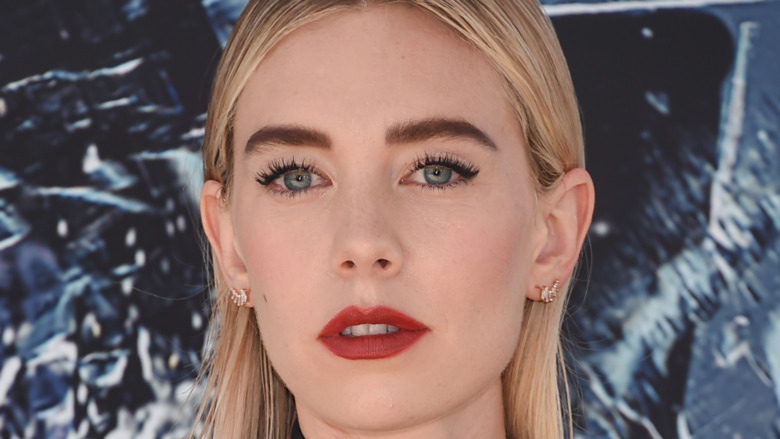 Vanessa Kirby gazing into camera wearing red lipstick