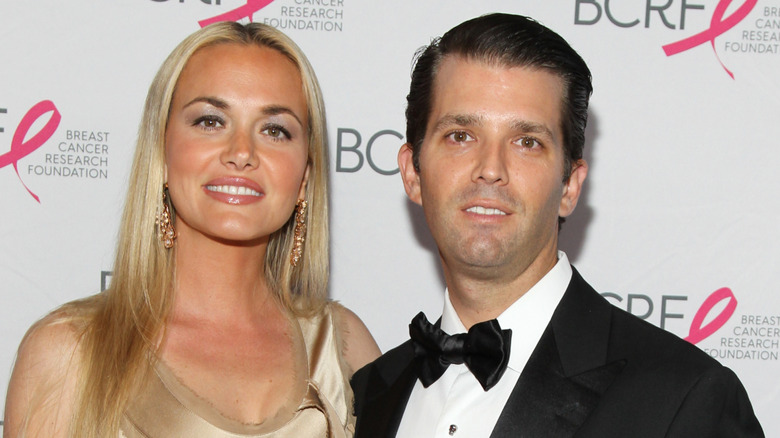Vanessa Trump wears her hair straight and down while posing beside Donald Trump Jr. at an event.
