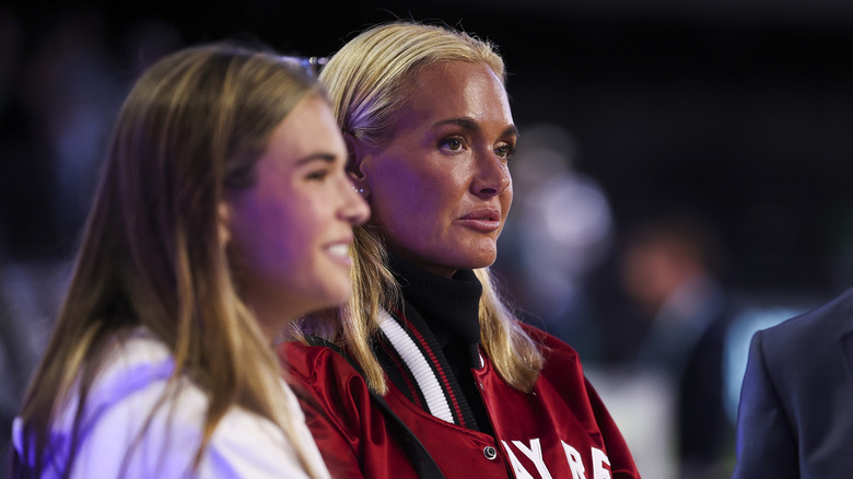 At a golf match, Kai Trump smiles beside Vanessa Trump, whose face has a deep tan.