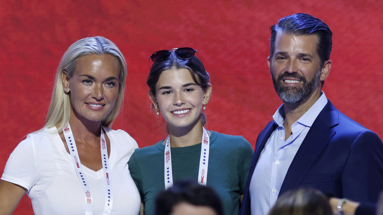 Vanessa Trump, Kai Trump and Donald Trump Jr., posing for photos on stage before the start of the third day of the Republican National Convention at the Fiserv Forum