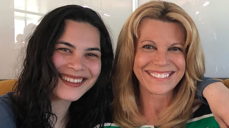 Gigi Santo Pietro posing with arm around Vanna White's shoulders as both women smile.