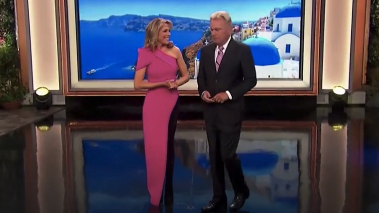 Vanna White wearing pink dress and black tights