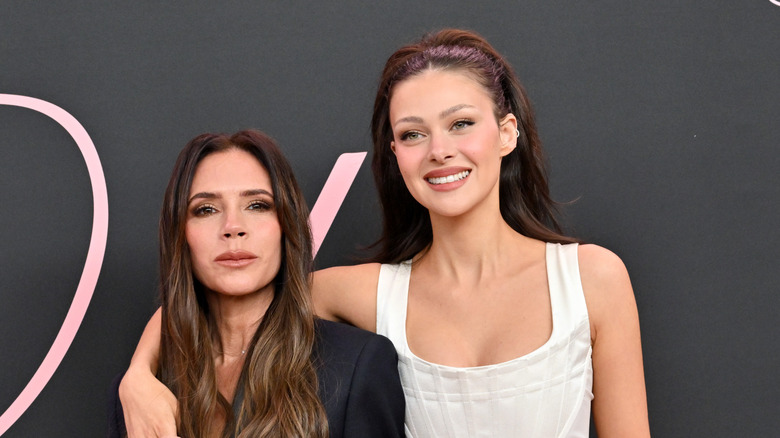 Victoria Beckham and Nicola Peltz posing