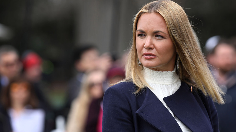 A close-up photo of Vanessa Trump wearing a white shirred turtleneck and navy blue coat.