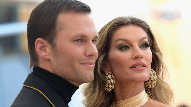 Tom Brady and Gisele Bündchen look off into distance