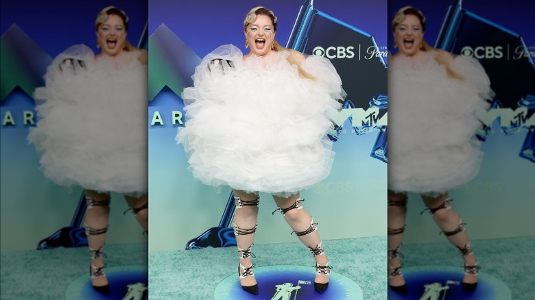 Meek wearing a white dress with layers of tulle.