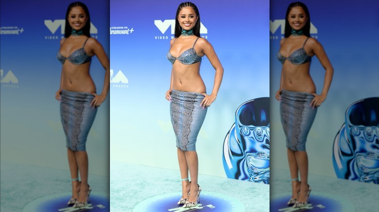 Tyla wearing a low-rise snakeskin skirt and matching bra top