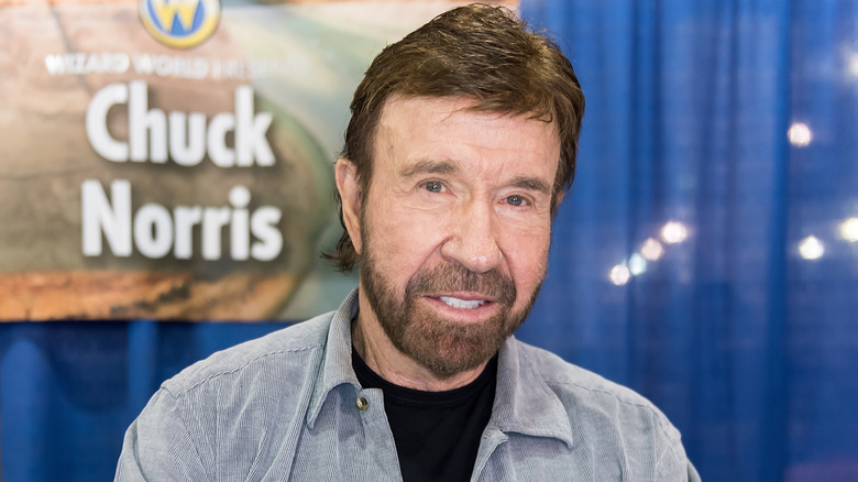 Chuck Norris smiling at an event.