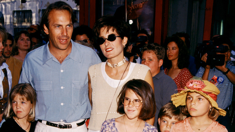 Kevin Costner, Cindy Silva posing with kids