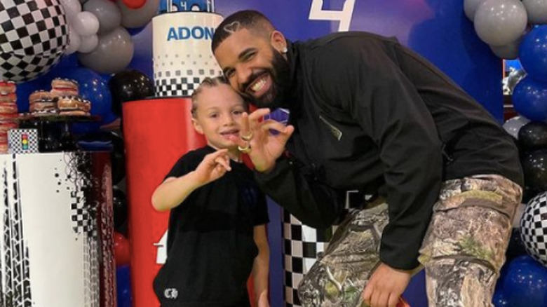 Drake and adonis posing at his birthday party 