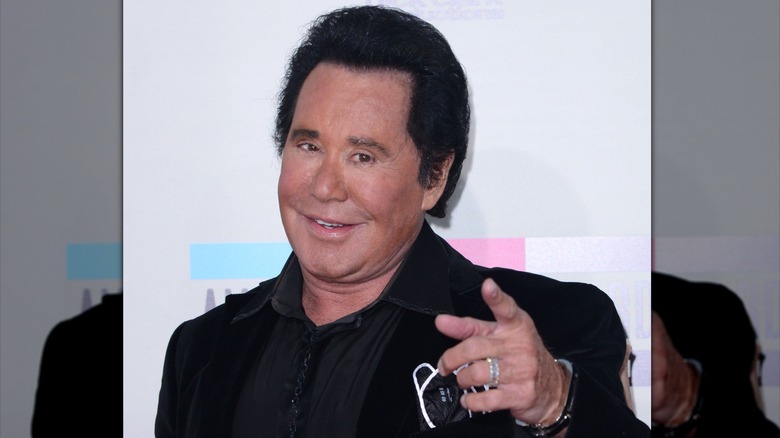 Wayne Newton pointing at the camera while posing for photos in 2013