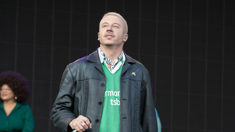 Macklemore wearing a leather jacket onstage in Dublin