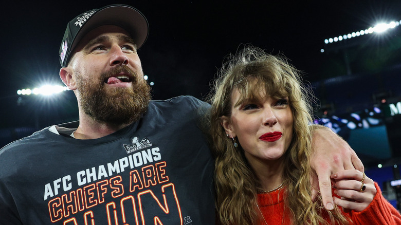 Travis Kelce with arm around Taylor Swift