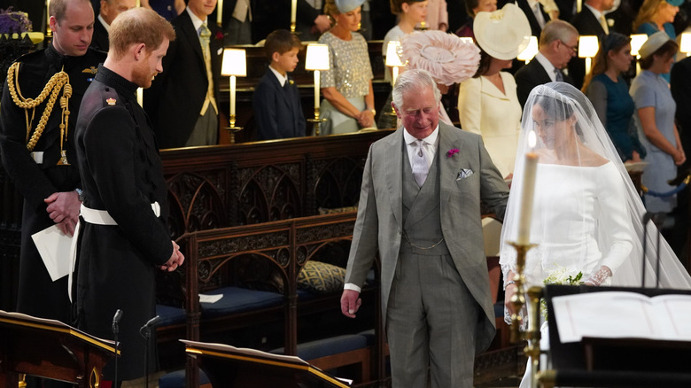 King Charles walks Meghan Markle down the aisle.