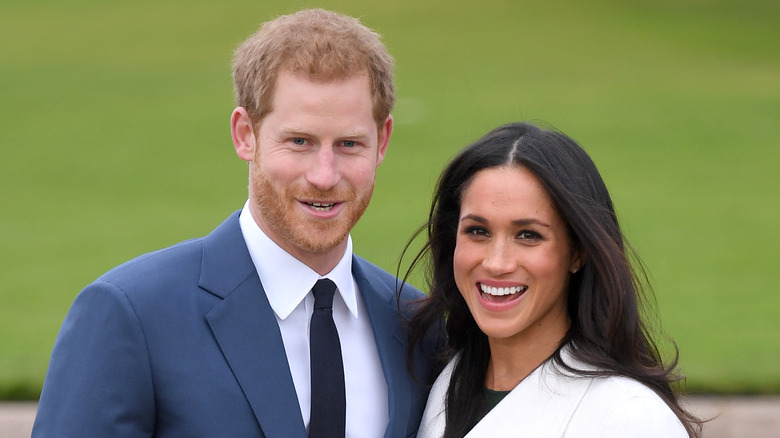 Prince Harry and Meghan Markle pose for a photo.