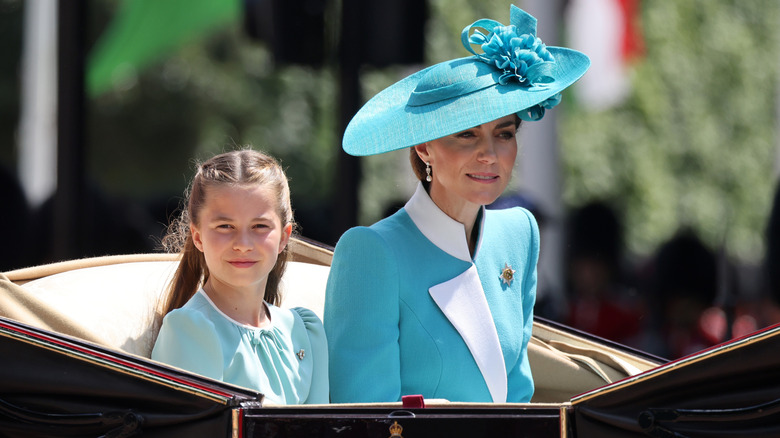 Princess Charlotte and Kate Middleton riding in a carriage during Trooping the Colour 2025