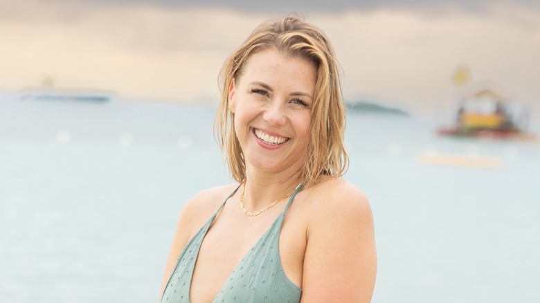 Jodie Sweetin smiling in a dress on the beach