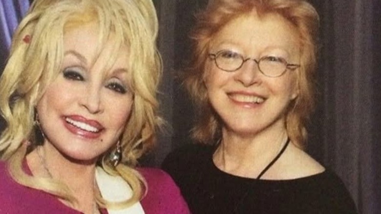 Dolly Parton smiling while posing with her best friend, Judy Ogle