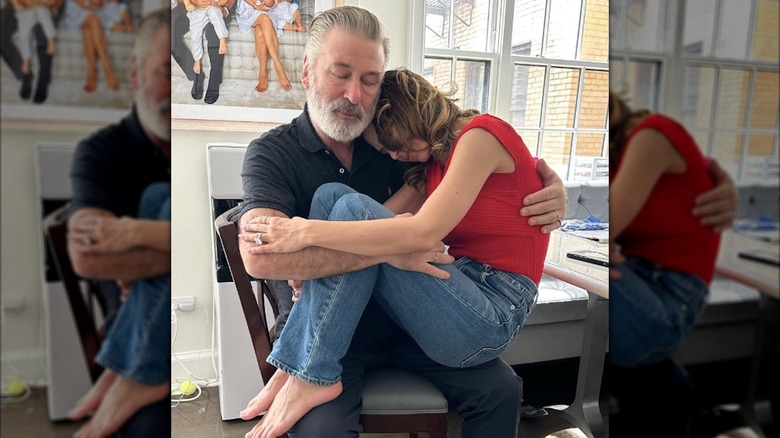Hilaria Baldwin on the lap of husband Alec Baldwin