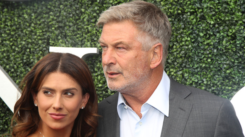 Hilaria Baldwin with husband Alec Baldwin posing in front of leaves