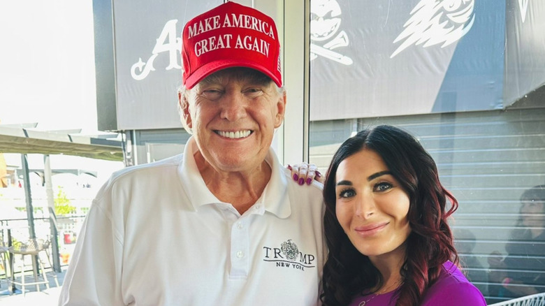 Donald Trump smiles with Laura Loomer