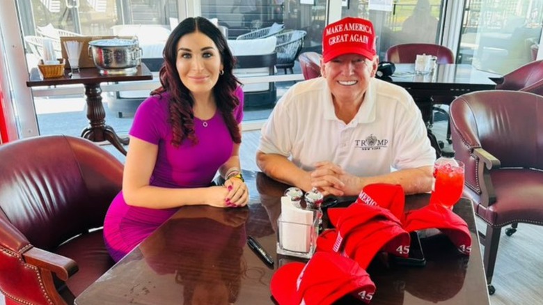 Laura Loomer sits with Donald Trump
