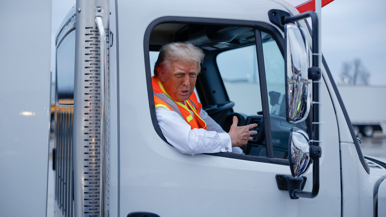 Donald Trump seated inside garbage truck